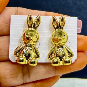 A pair of whimsical, golden bunny-shaped stud earrings.