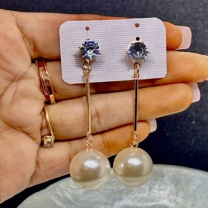 A pair of sophisticated dangle earrings with multiple small pearls hanging from a gold or silver wire.