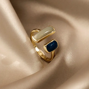 A golden ring with a small, colorful enameled design. The ring is also platinum plated for extra durability.