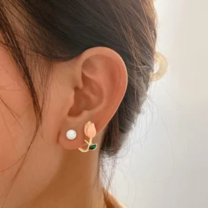 A pair of small stud earrings shaped like a pink tulip flower.