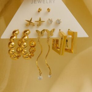 Various styles of gold earrings on a display card