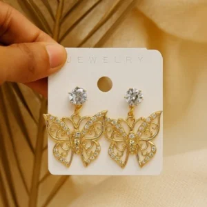Gold butterfly earrings with intricate design on display